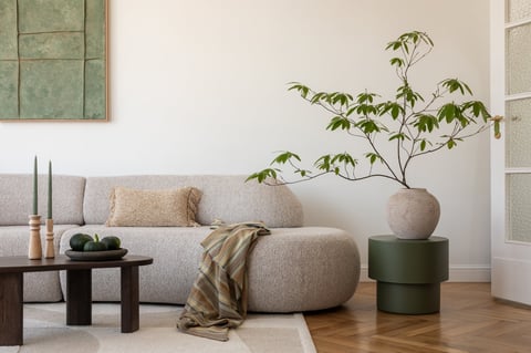 Stylish modern living room with spacious sofa and minimalist decor in earthy tones creating a warm and inviting atmosphere