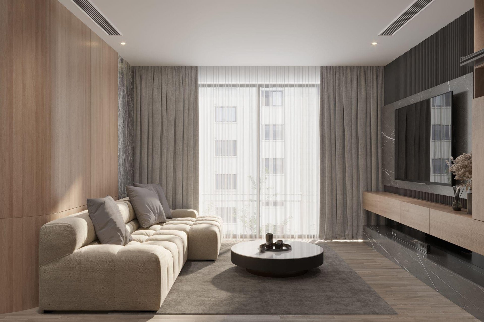 Modern living room with beige sectional sofa, dark coffee table, floor-to-ceiling windows with gray curtains, and wall-mounted TV